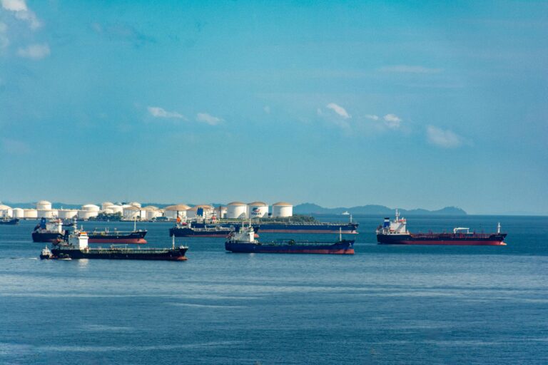 Oil tankers and storage facility illustrating energy sector growth and the importance of TSP diversification for federal employees